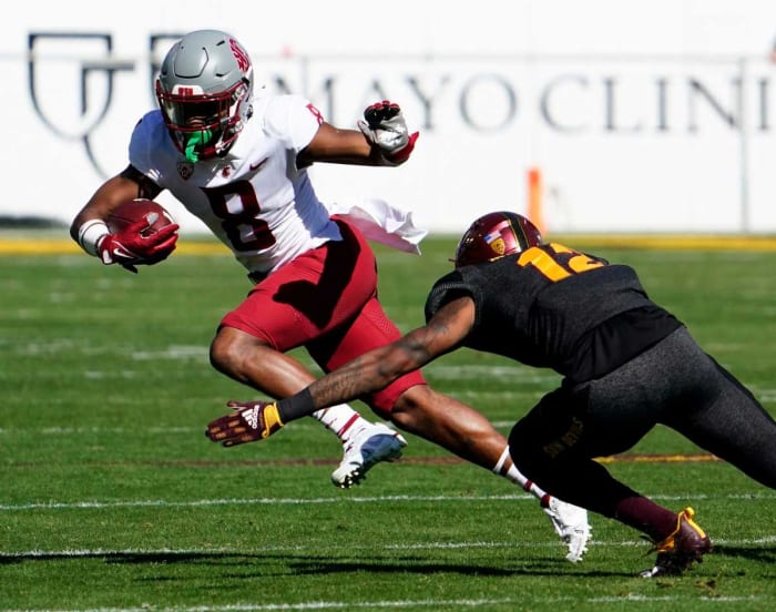 Washington State Cougars wide receiver Calvin Jackson Jr. (8) is tackled by Arizona State Sun Devils defensive back Kejuan Markham (12).